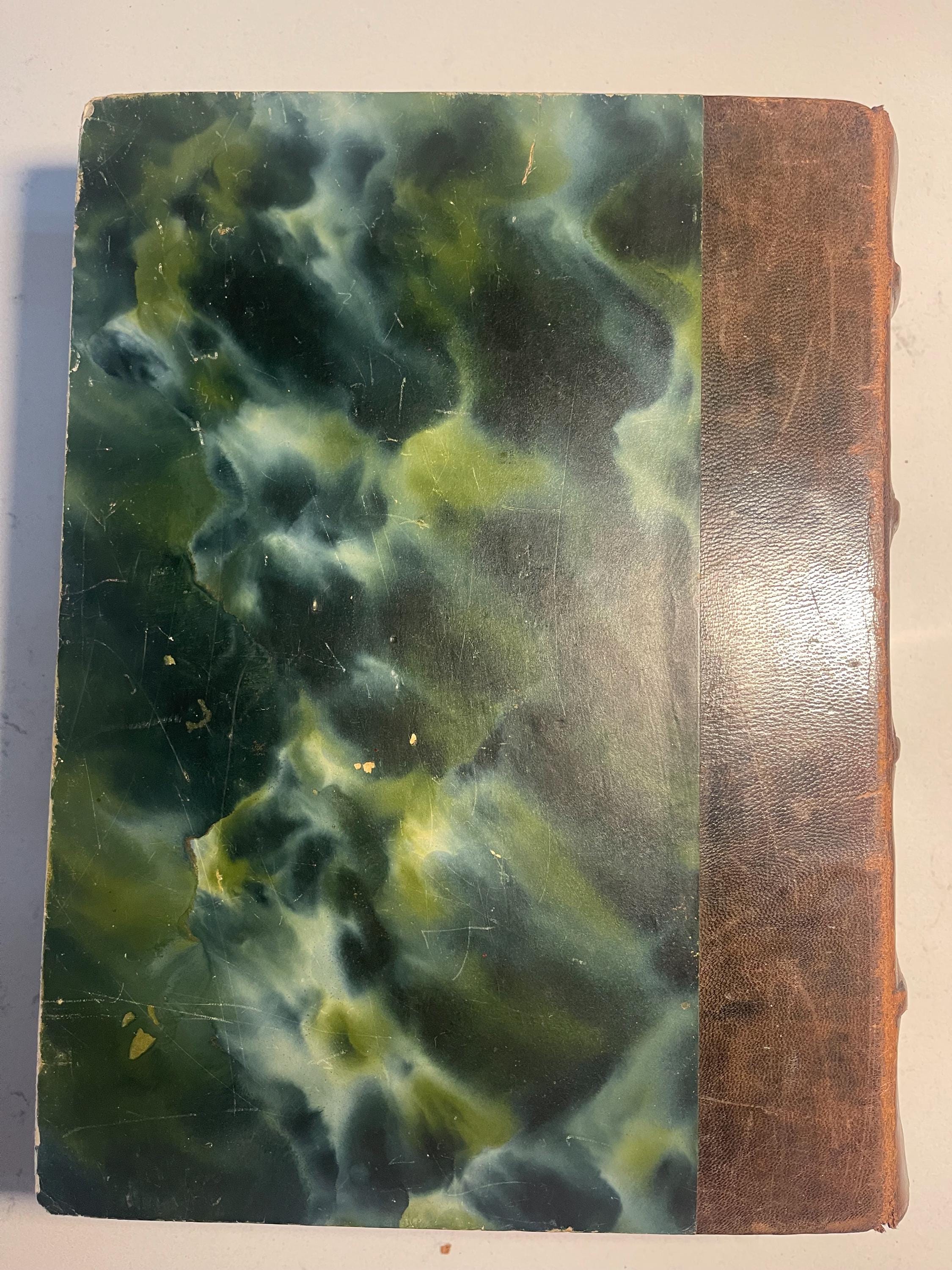 Larousse Gastronomique published in 1938 with leather spine and green marbled cover and end papers. Iconic piece of gastronomic history.