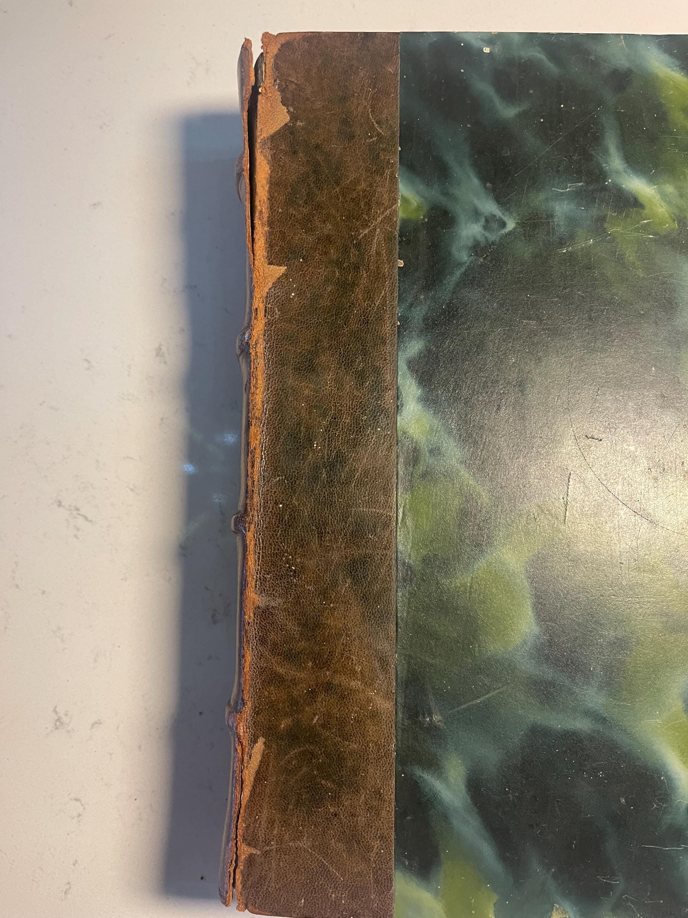 Larousse Gastronomique published in 1938 with leather spine and green marbled cover and end papers. Iconic piece of gastronomic history.