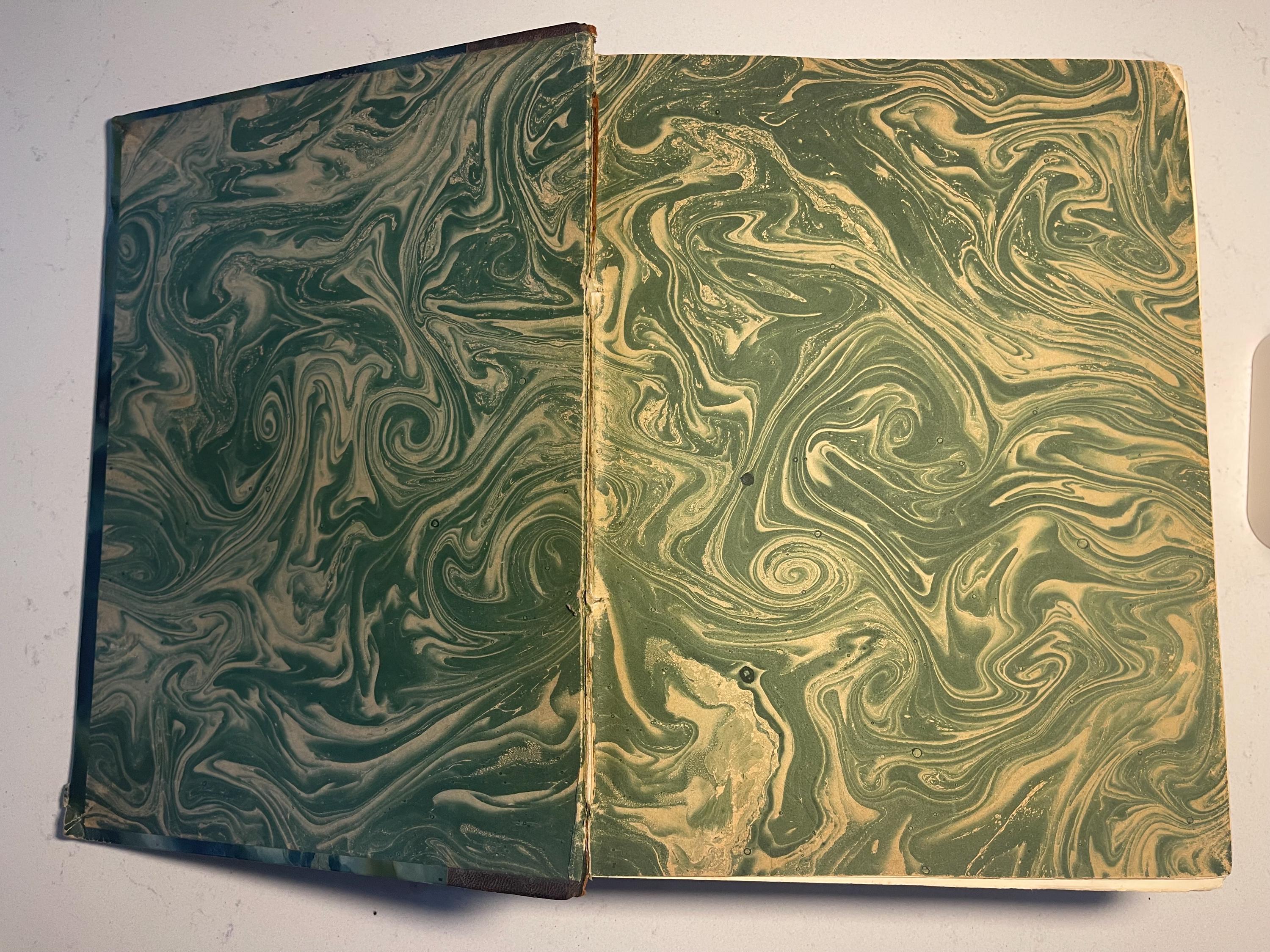 Larousse Gastronomique published in 1938 with leather spine and green marbled cover and end papers. Iconic piece of gastronomic history.