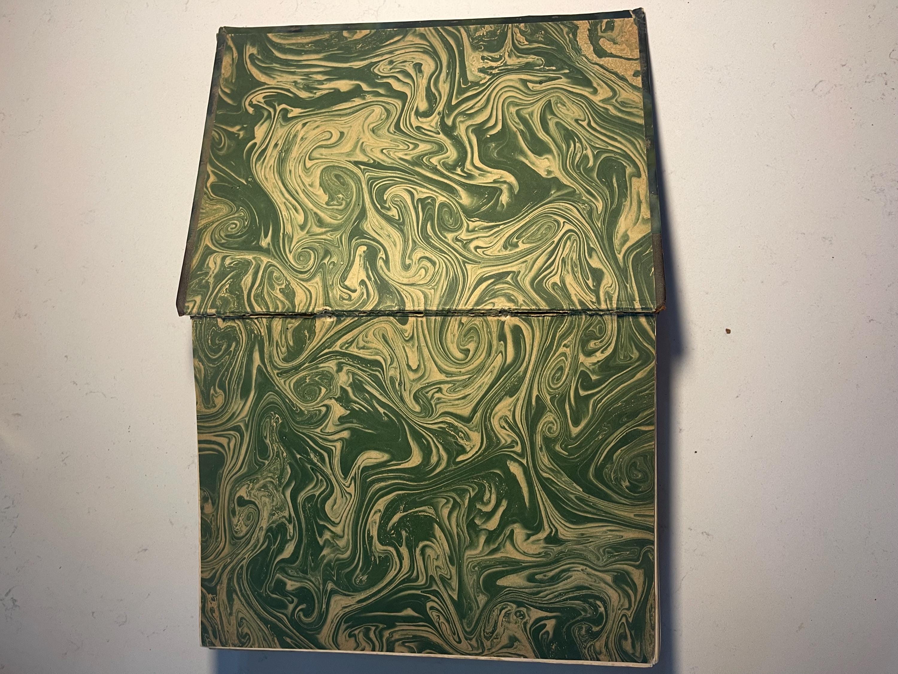 Larousse Gastronomique published in 1938 with leather spine and green marbled cover and end papers. Iconic piece of gastronomic history.