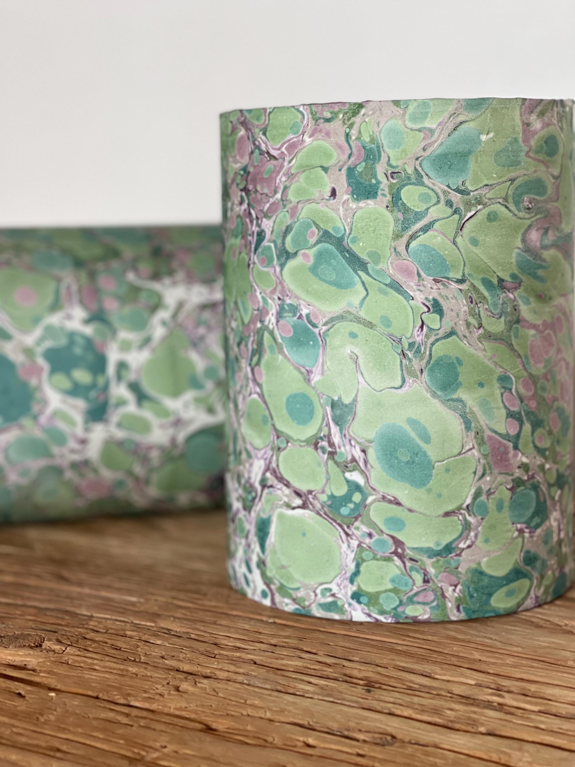 A pair of unique silk green and plum hand marbled drum table lampshades ideal as table or bedside lamps