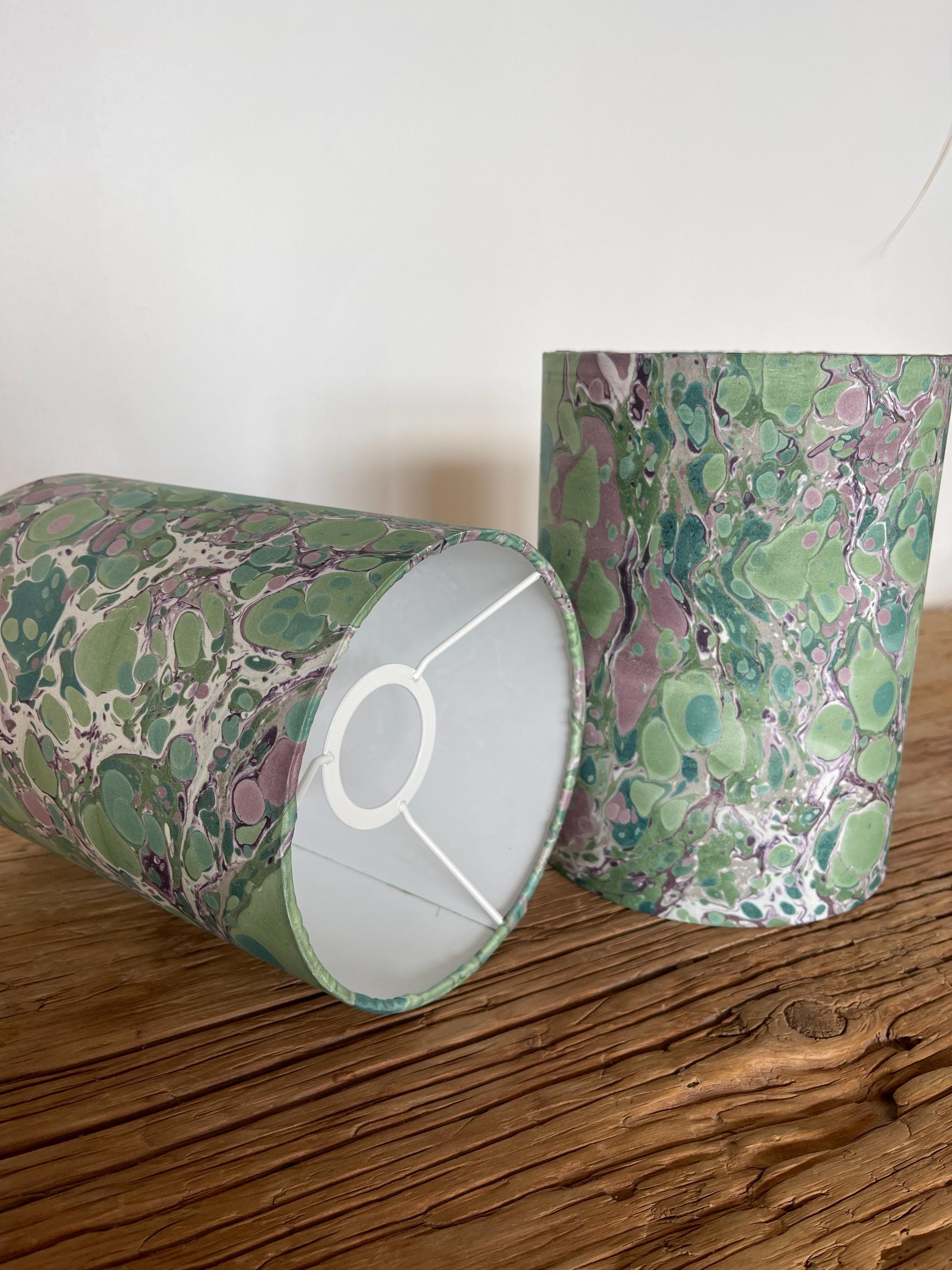 A pair of unique silk green and plum hand marbled drum table lampshades ideal as table or bedside lamps
