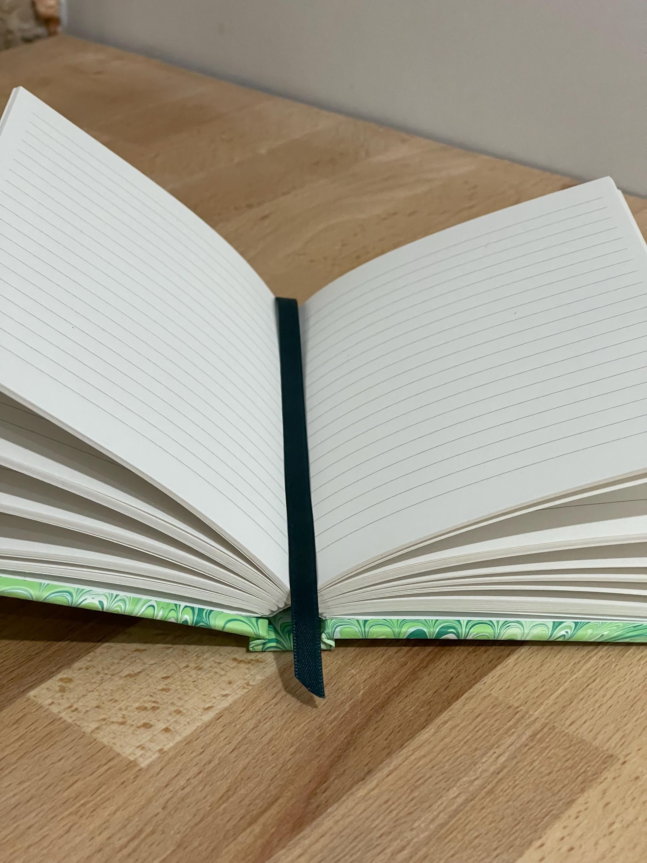 Hand marbled/painted notebook journal in a green non pareil pattern with a green book mark and recycled white lined pages
