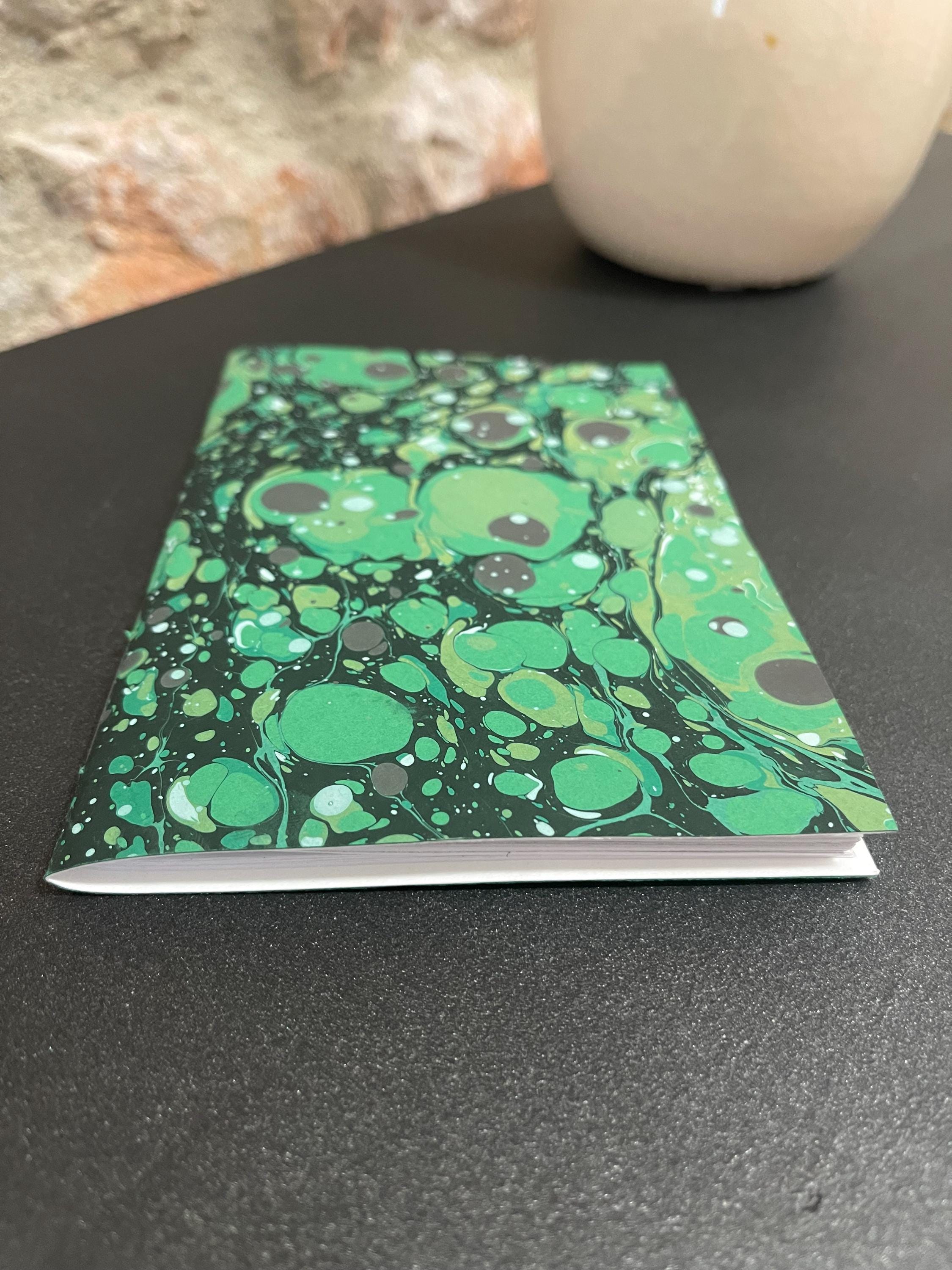 Hand sewn, hand marbled pocket notebook, A6, soft cover in greens, greys and blacks with 80 pages of lined 80g/m2 paper. Unique gift.
