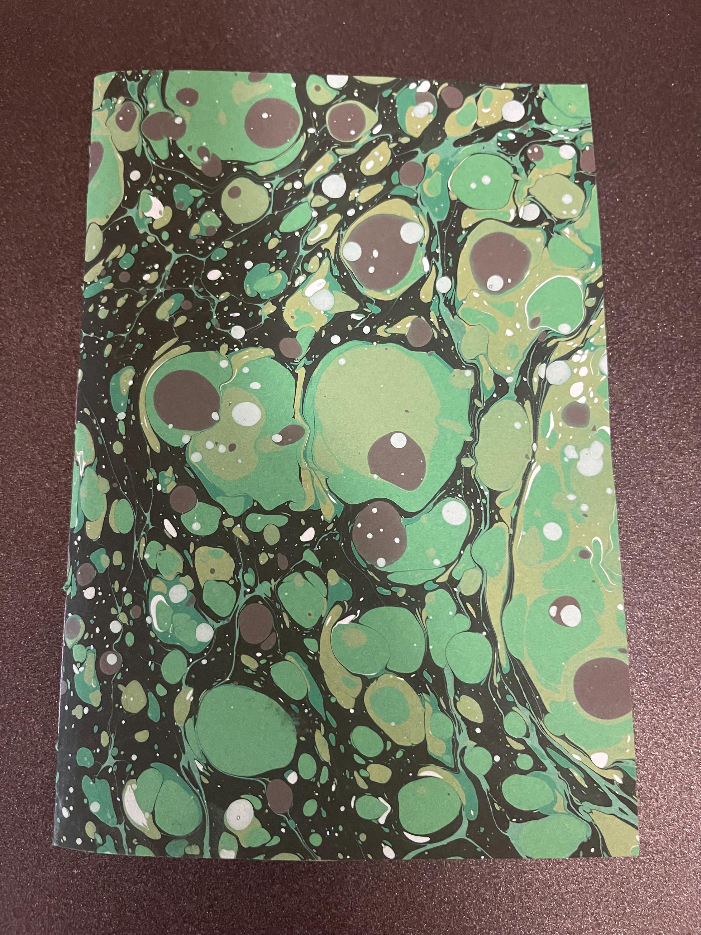 Hand sewn, hand marbled pocket notebook, A6, soft cover in greens, greys and blacks with 80 pages of lined 80g/m2 paper. Unique gift.
