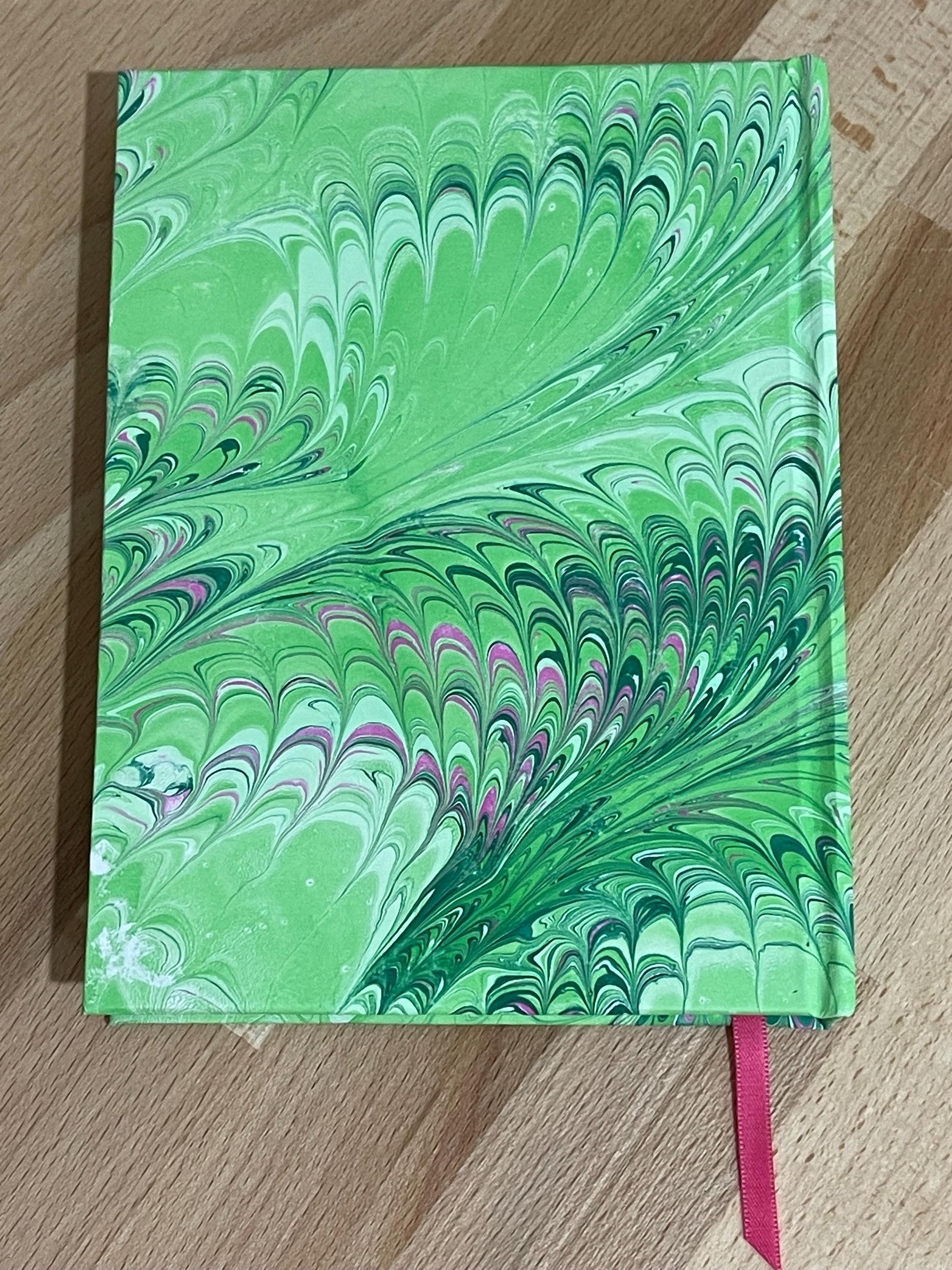 Hand marbled/painted notebook journal in a green and pink non pareil pattern with a pink book mark and recycled white lined pages