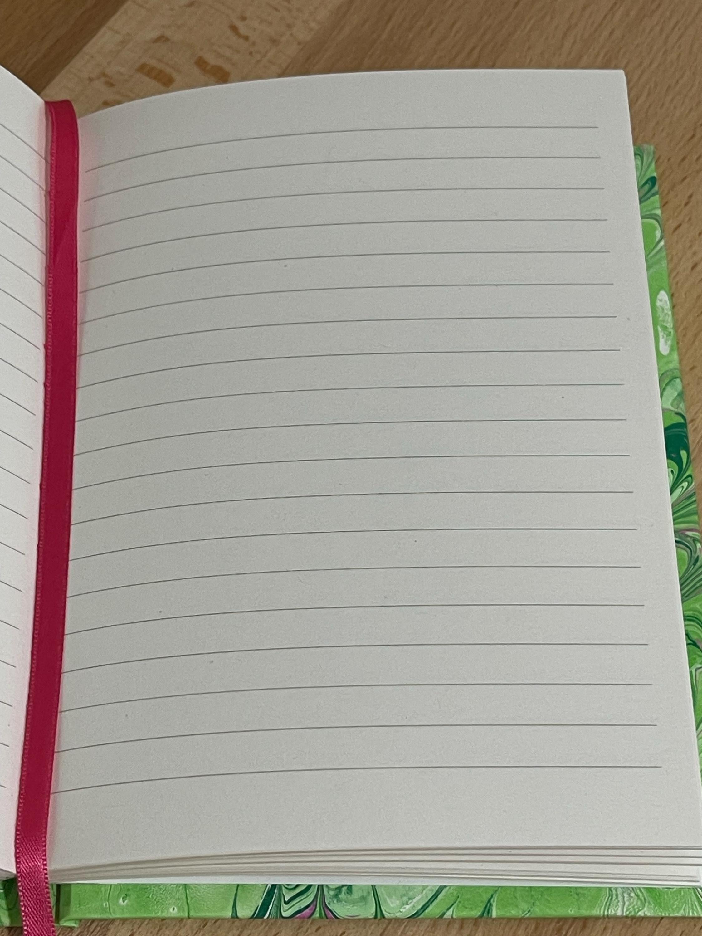 Hand marbled/painted notebook journal in a green and pink non pareil pattern with a pink book mark and recycled white lined pages
