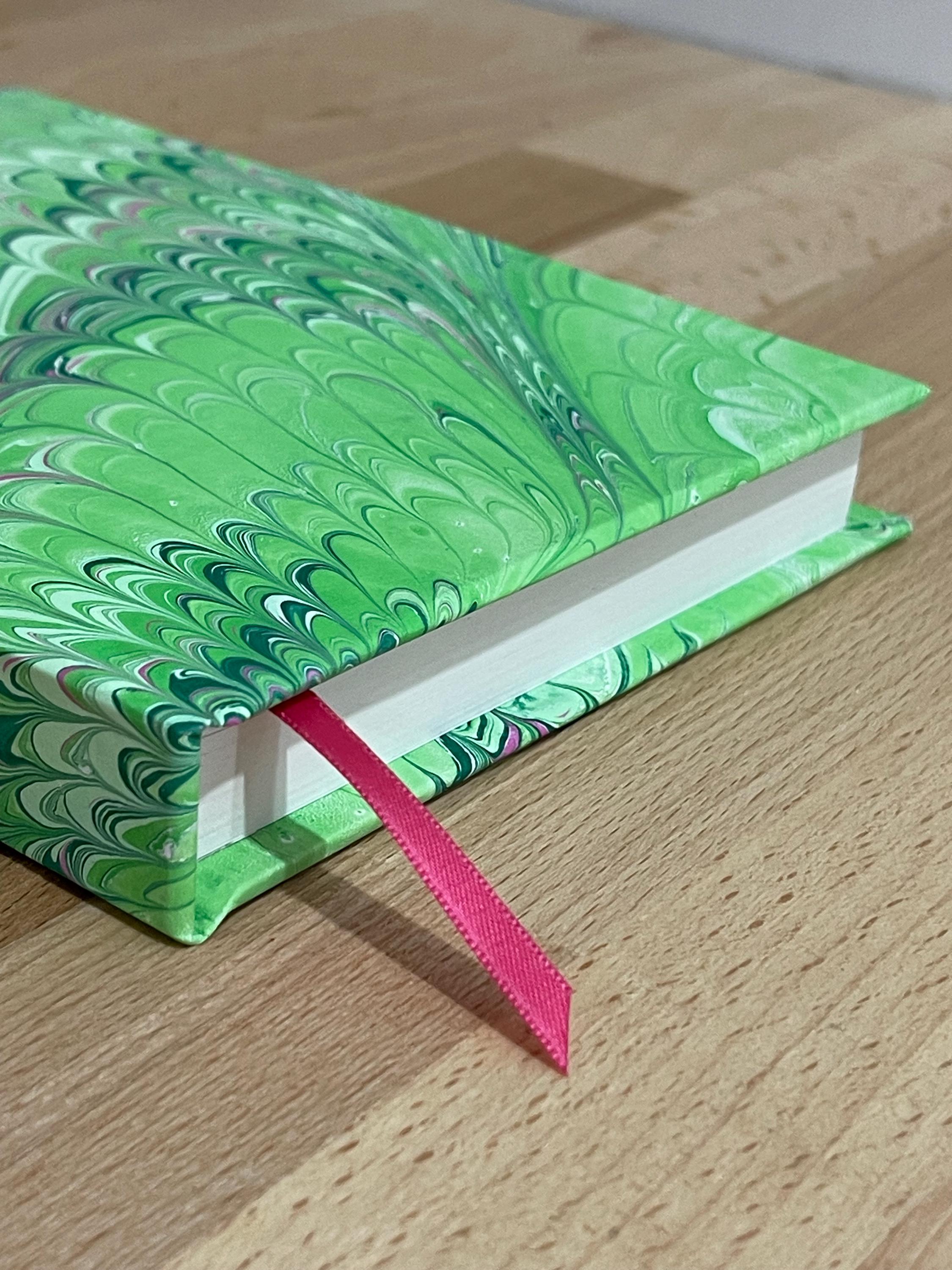 Hand marbled/painted notebook journal in a green and pink non pareil pattern with a pink book mark and recycled white lined pages
