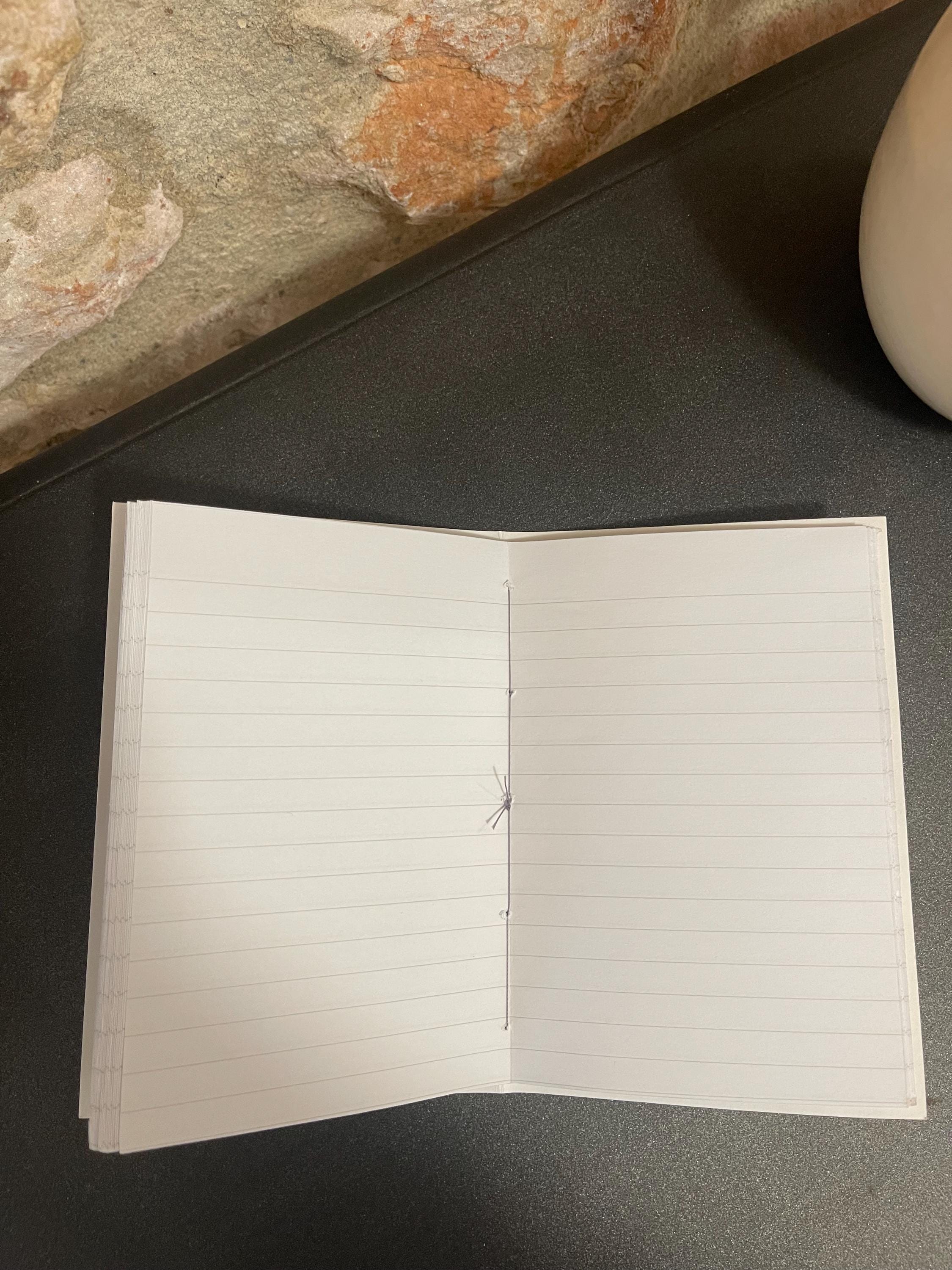Hand sewn, hand marbled pocket notebook, A6, soft cover in greens, greys and blacks with 80 pages of lined 80g/m2 paper. Unique gift.