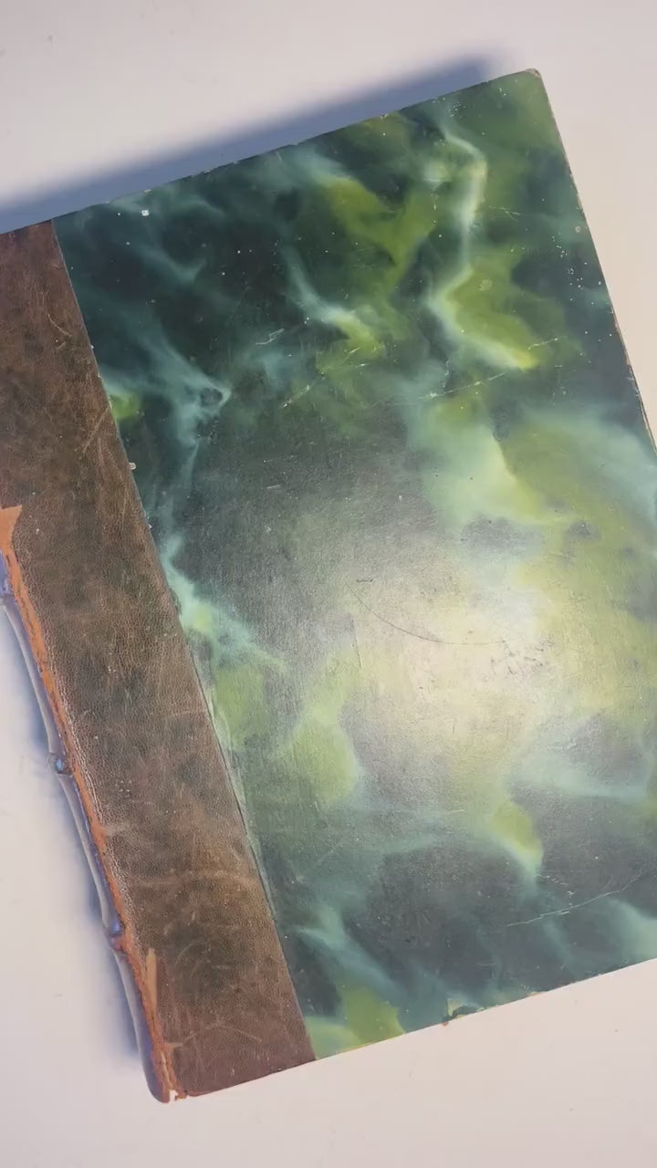 Larousse Gastronomique published in 1938 with leather spine and green marbled cover and end papers. Iconic piece of gastronomic history.